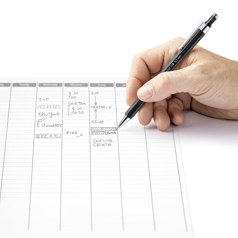 Hand writing appointments in a weekly planner with a black Staedtler graphite 778 mechanical pencil