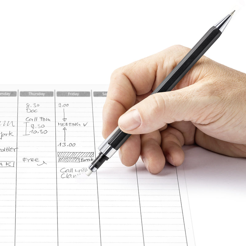 Hand using the twist eraser on the end of a graphite 778 to correct an entry in a planner