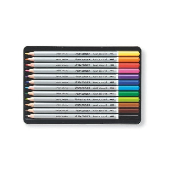 Twelve karat aquarell pencils lined up in their black insert tray, colours running from yellow through reds and blues to black