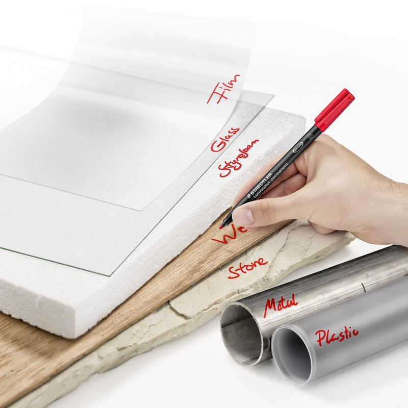 Hand writing with a red Lumocolor pen on film, glass, styrofoam, wood, stone, metal and plastic pipe, range photo