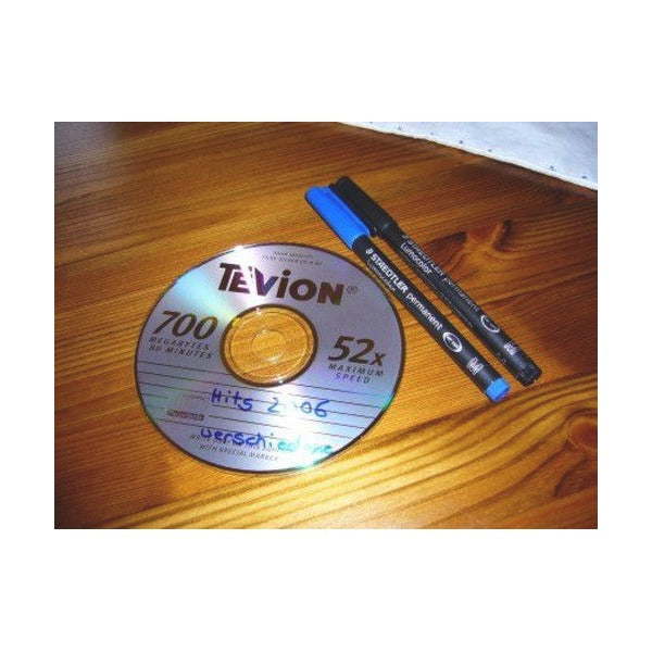 Older photo of a blue and a black Lumocolor permanent pen resting on a CD with handwritten text on the disc