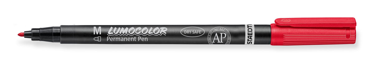 Red Staedtler Lumocolor permanent 317-2 medium pen lying flat, uncapped, with M on the black barrel