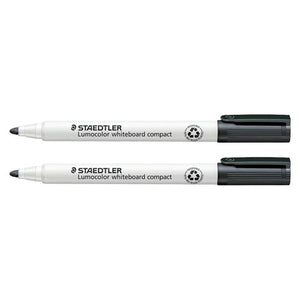 Two black Staedtler Lumocolor whiteboard compact markers lying side by side, capped, with white barrels and the barrel print visible