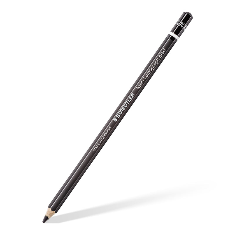 Single Mars Lumograph black pencil with a black barrel and white ring, sharpened and shown at an angle