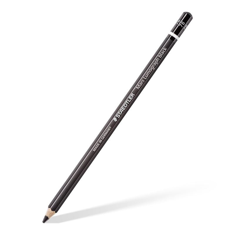 A single black Mars Lumograph black pencil on a diagonal, sharpened tip at the bottom and white ring near the end