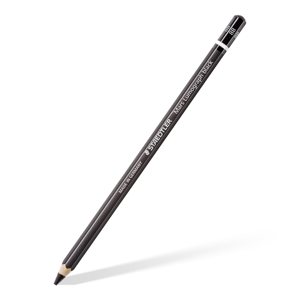Mars Lumograph black 8B pencil on white, black barrel with a white ring, laid diagonally with the point at the bottom