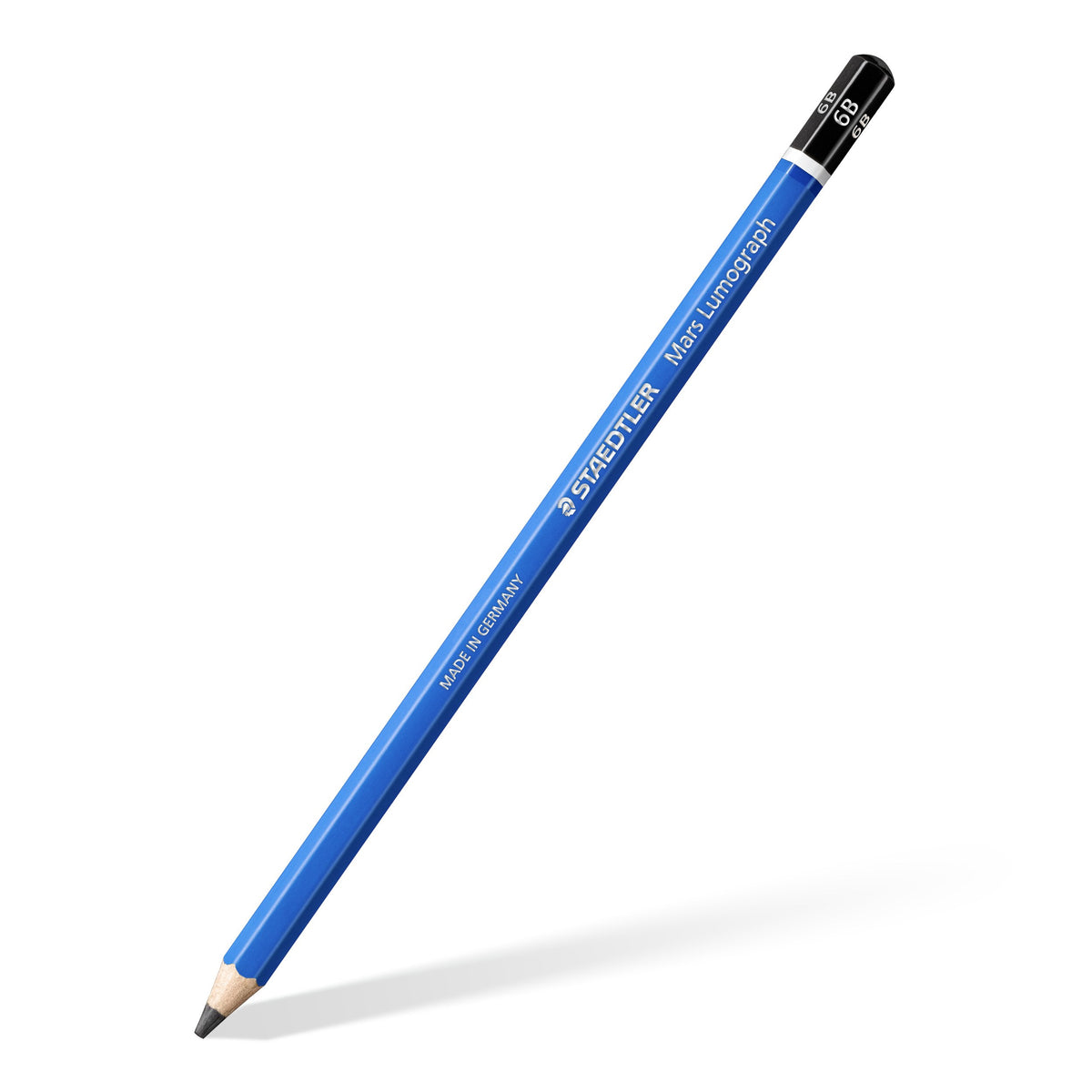 One blue Mars Lumograph 6B pencil lying diagonally with a sharpened point, black end cap printed 6B and silver STAEDTLER lettering on the barrel