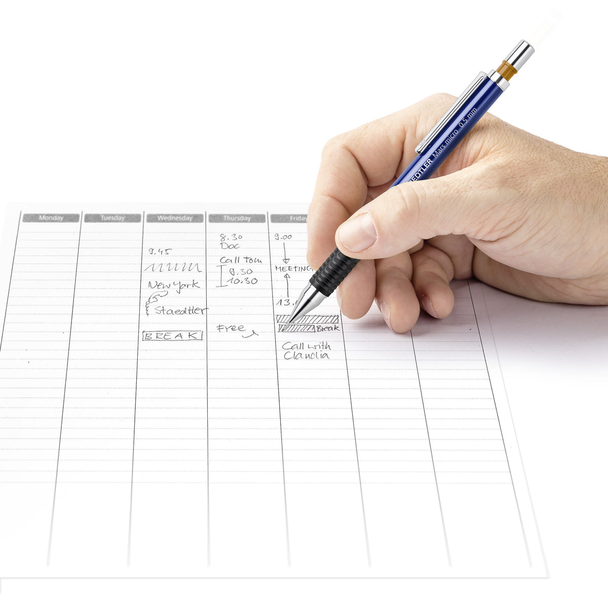 Hand noting appointments in a weekly planner with a blue Mars micro mechanical pencil