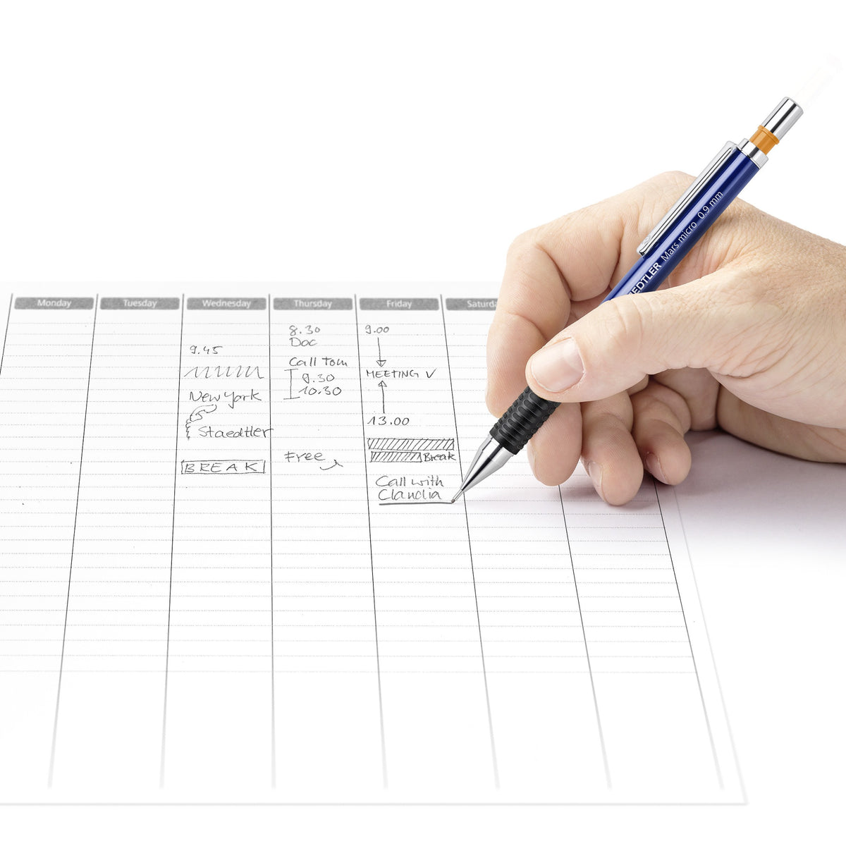 Hand writing entries in a weekly planner with a Mars micro 0.9 mm pencil