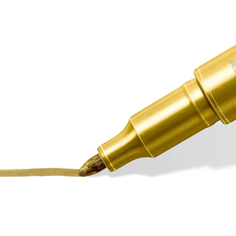 Close-up of a gold Staedtler metallic pen bullet tip laying down a gold line, one of the colours in the set