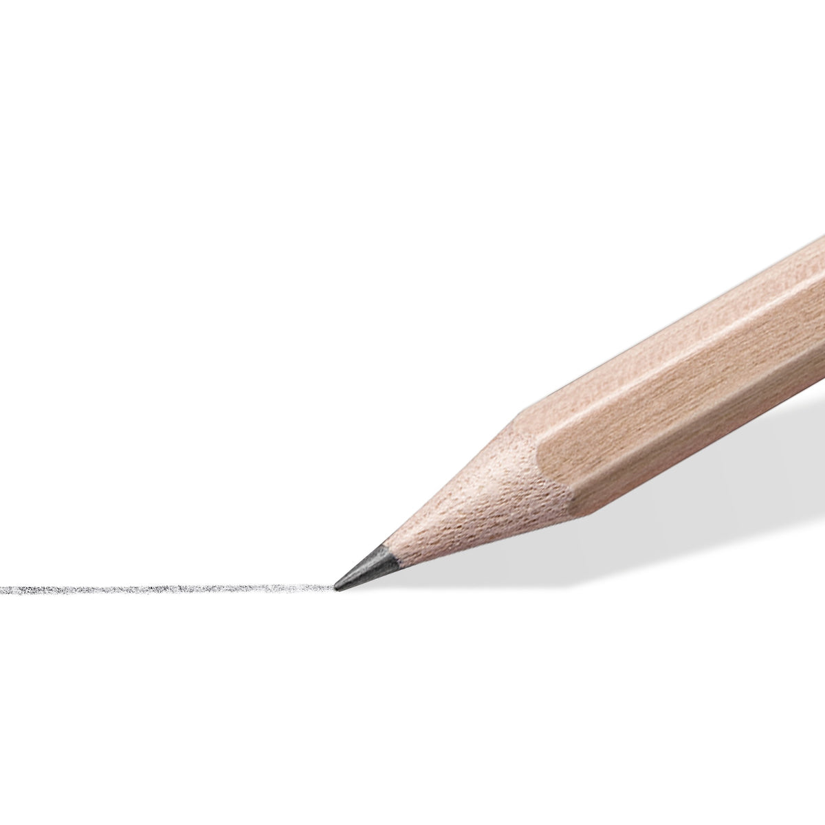 Close-up of a sharpened Staedtler natural pencil drawing a soft grey graphite line