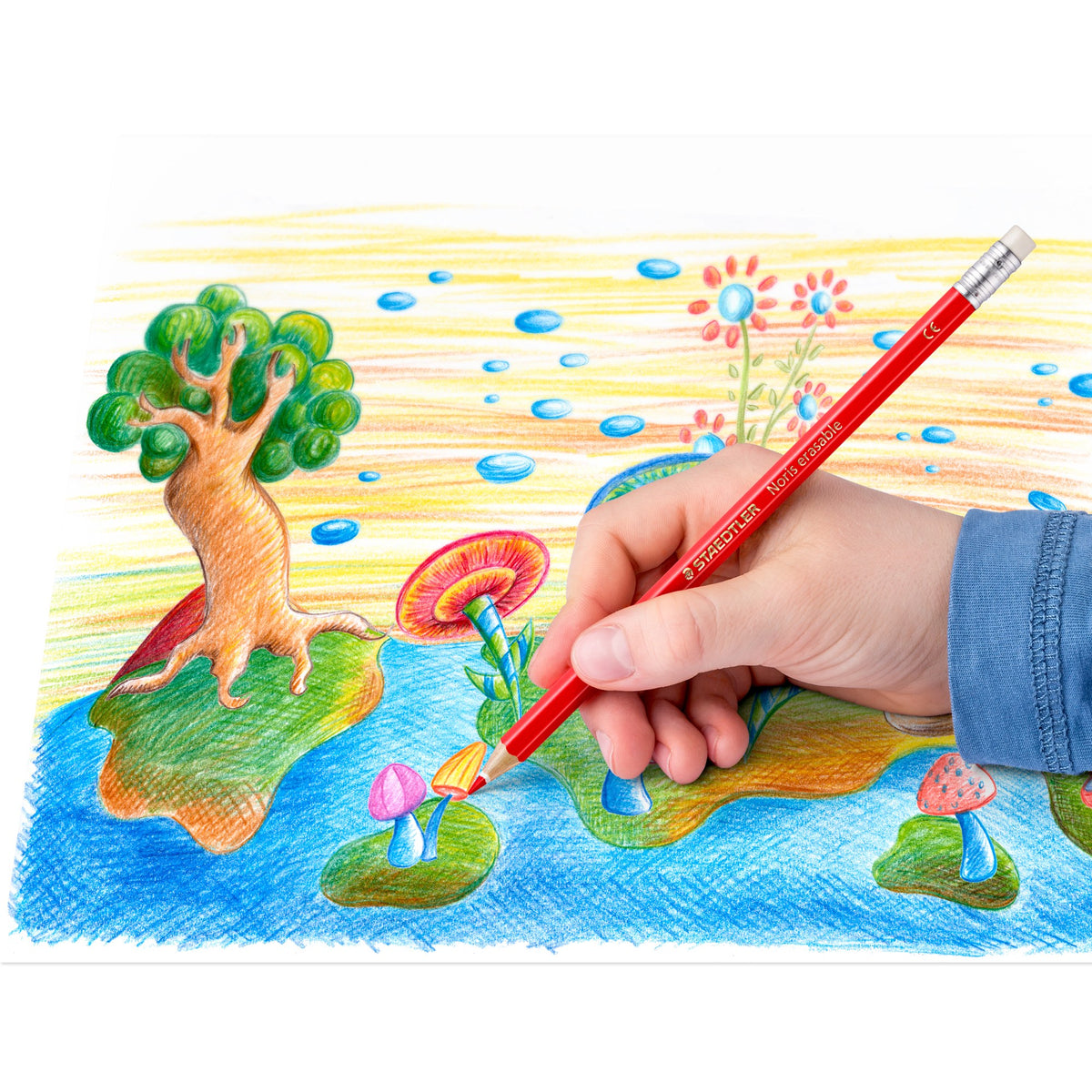 A child colours a tree on a mushroom island with a red erasable coloured pencil