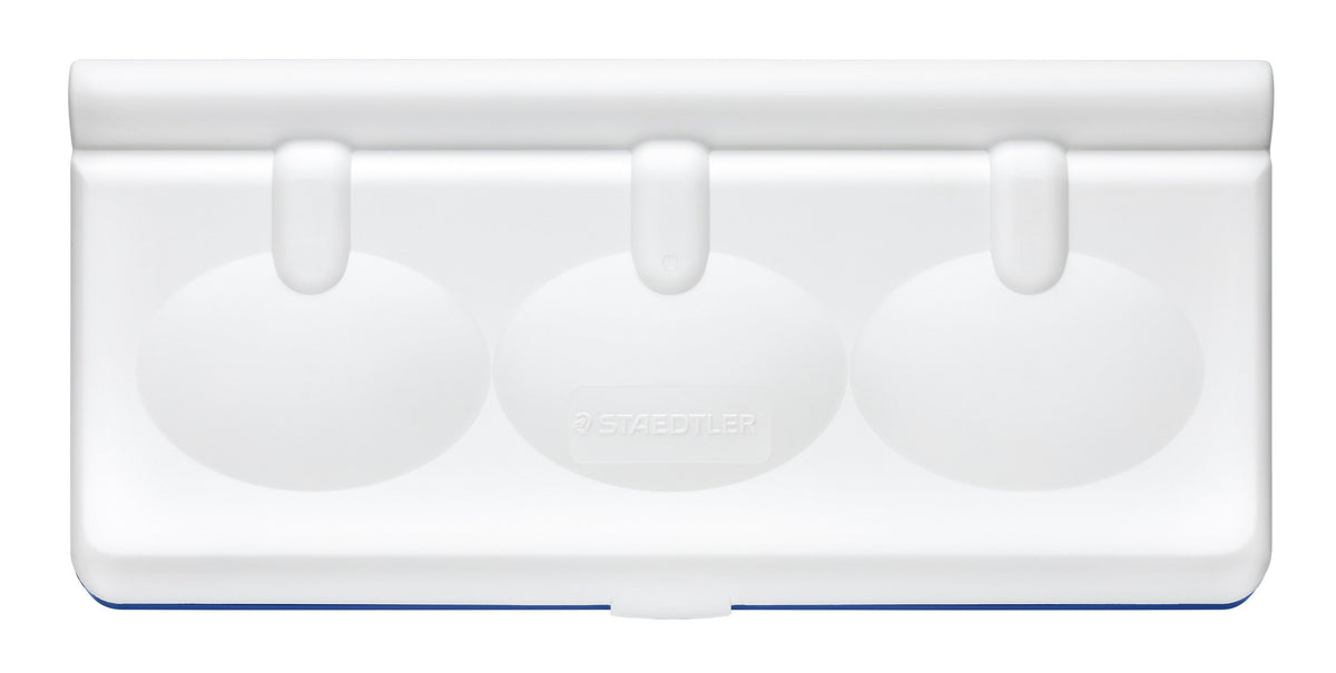 The white lid of the Noris paint box seen from above, three oval mixing wells moulded into the palette