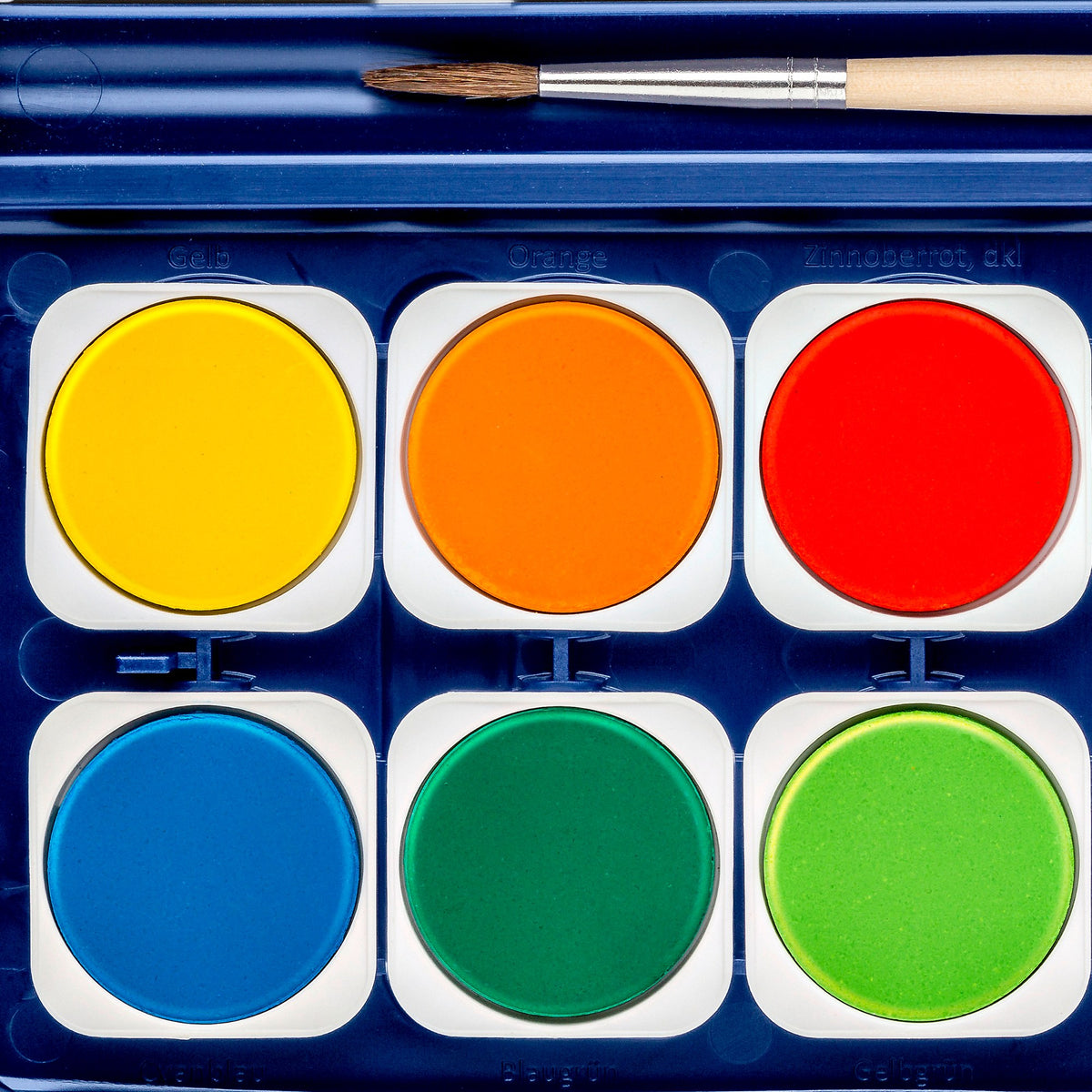 Close-up of six Noris watercolour pots in yellow, orange, red, blue, green and light green, with the brush resting above