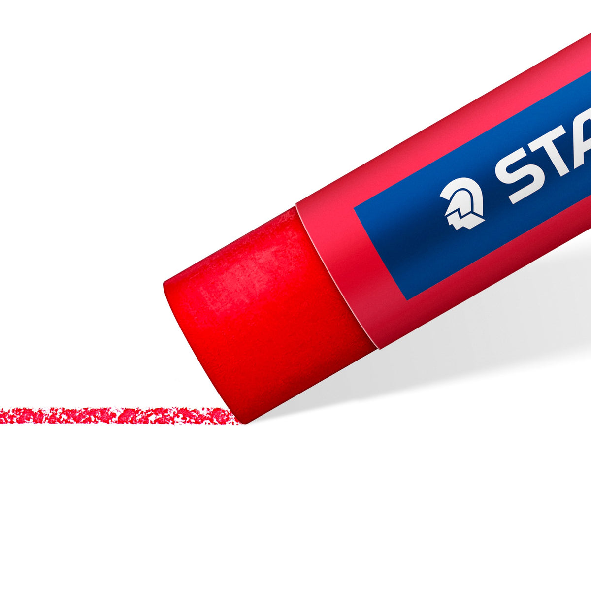 Red Staedtler oil pastel close up, drawing a waxy red stroke on white paper; range image