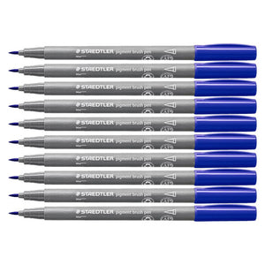 Ten Staedtler pigment brush pens in colour 3 blue lined up in a stack, grey barrels with blue caps and fine brush tips pointing left