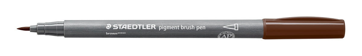 Uncapped Staedtler 371-76 pigment brush pen side on, grey barrel with white print, brown brush tip at left and brown cap posted on the end