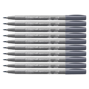 Ten Staedtler pigment brush pens in 871 cool grey dark stacked together, grey barrels with dark slate caps and brush tips to the left