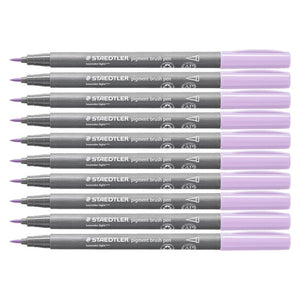 Ten Staedtler pigment brush pens in lavender light laid side by side, grey barrels printed with the Staedtler logo and lavender light caps, brush tips pointing left