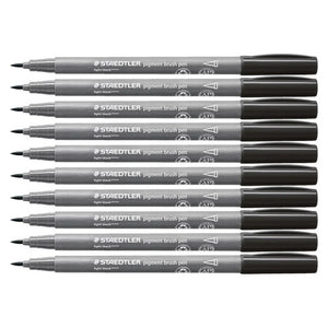 Ten Staedtler pigment brush pens in light black laid side by side, grey barrels printed with the Staedtler logo and light black caps, brush tips pointing left
