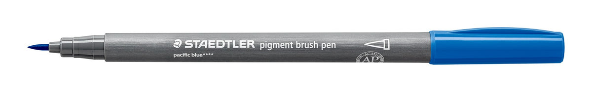 Staedtler 371-39 pigment brush pen in pacific blue lying open on white, grey barrel, pacific blue cap posted on the end and the pointed brush nib at left