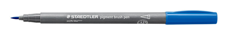 Staedtler 371-39 pigment brush pen in pacific blue lying open on white, grey barrel, pacific blue cap posted on the end and the pointed brush nib at left