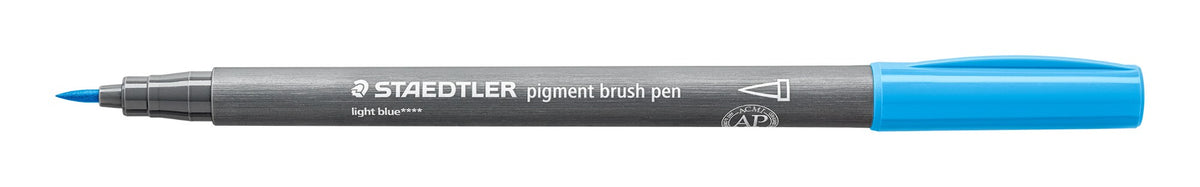 Staedtler 371-30 pigment brush pen in pale blue lying open on white, grey barrel, pale blue cap posted on the end and the pointed brush nib at left