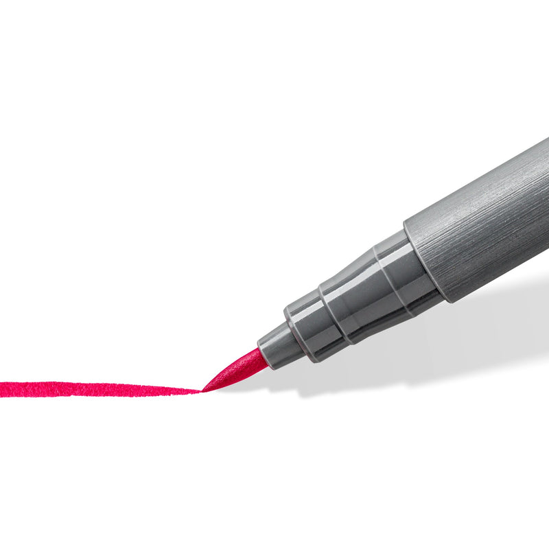 Close-up of a Staedtler pigment brush pen nib drawing a curved line, a 371 range photo taken with the bordeaux pen, not the turquoise colour
