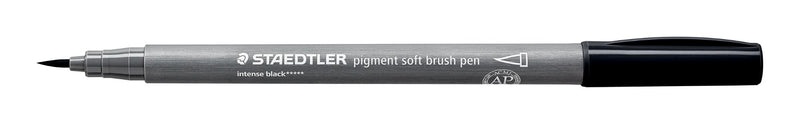 Uncapped Staedtler 372-99 soft brush pen side on, grey barrel printed intense black, brush tip at left and black cap posted on the end
