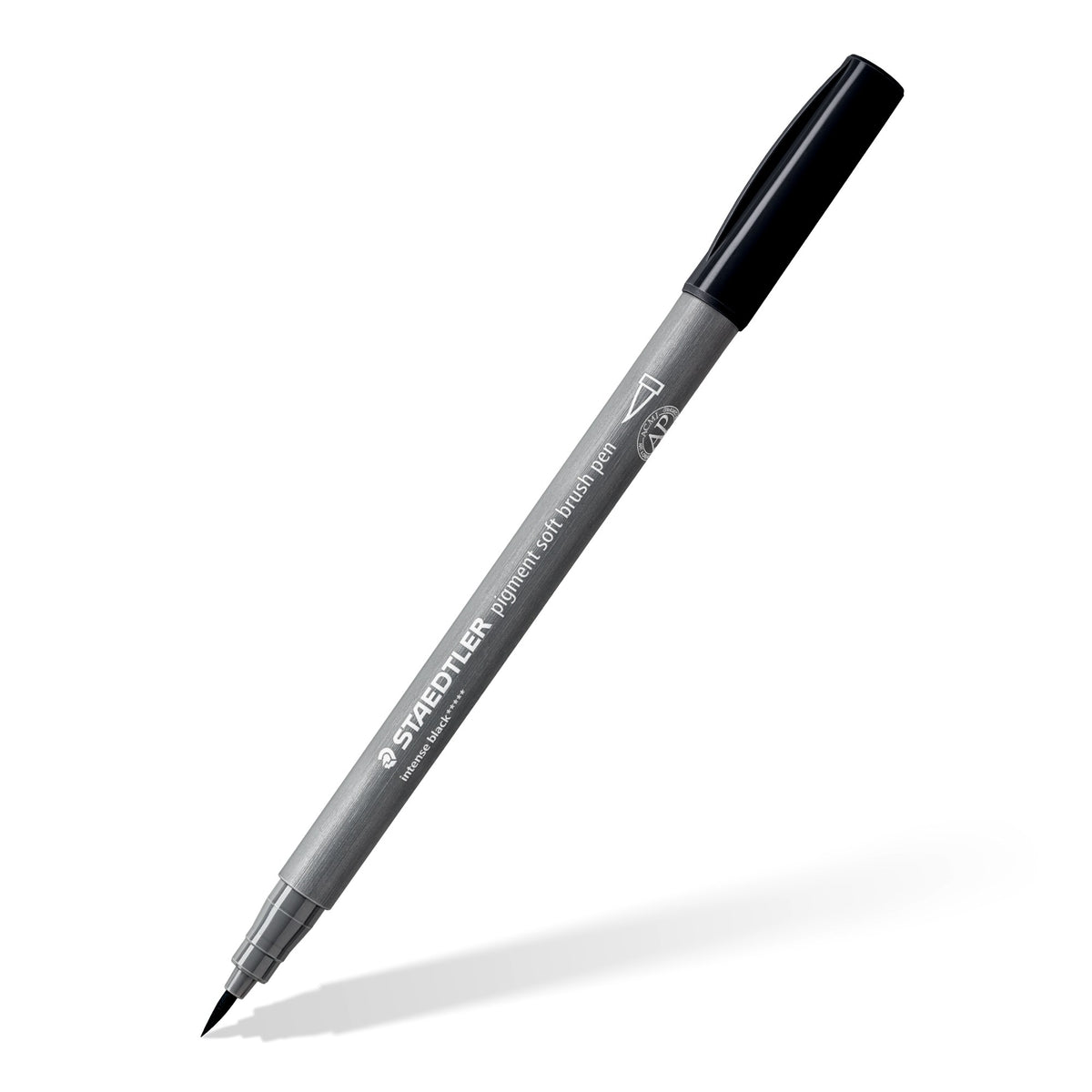 Staedtler 372 pigment soft brush pen in intense black lying at an angle with its cap on, grey barrel and black cap