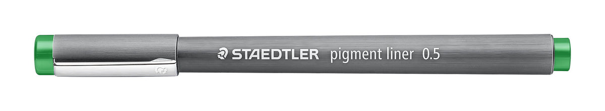 The green Staedtler pigment liner 0.5 with its cap on, showing the silver clip and the green band at the end of the barrel