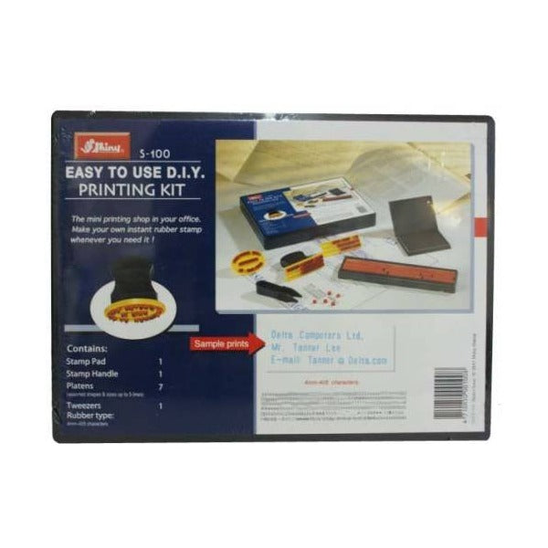 Shiny S-100 Easy to Use D.I.Y. Printing Kit pack front in navy, listing stamp pad, stamp handle, 7 platens, tweezers and 4mm rubber type, with a photo of the kit in use
