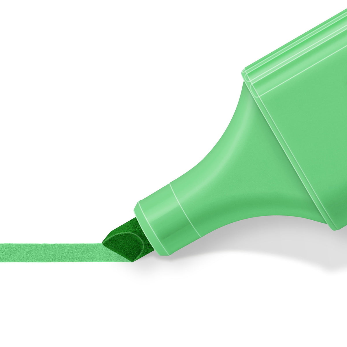 Close-up of the pale green chisel tip drawing a broad stroke across white paper