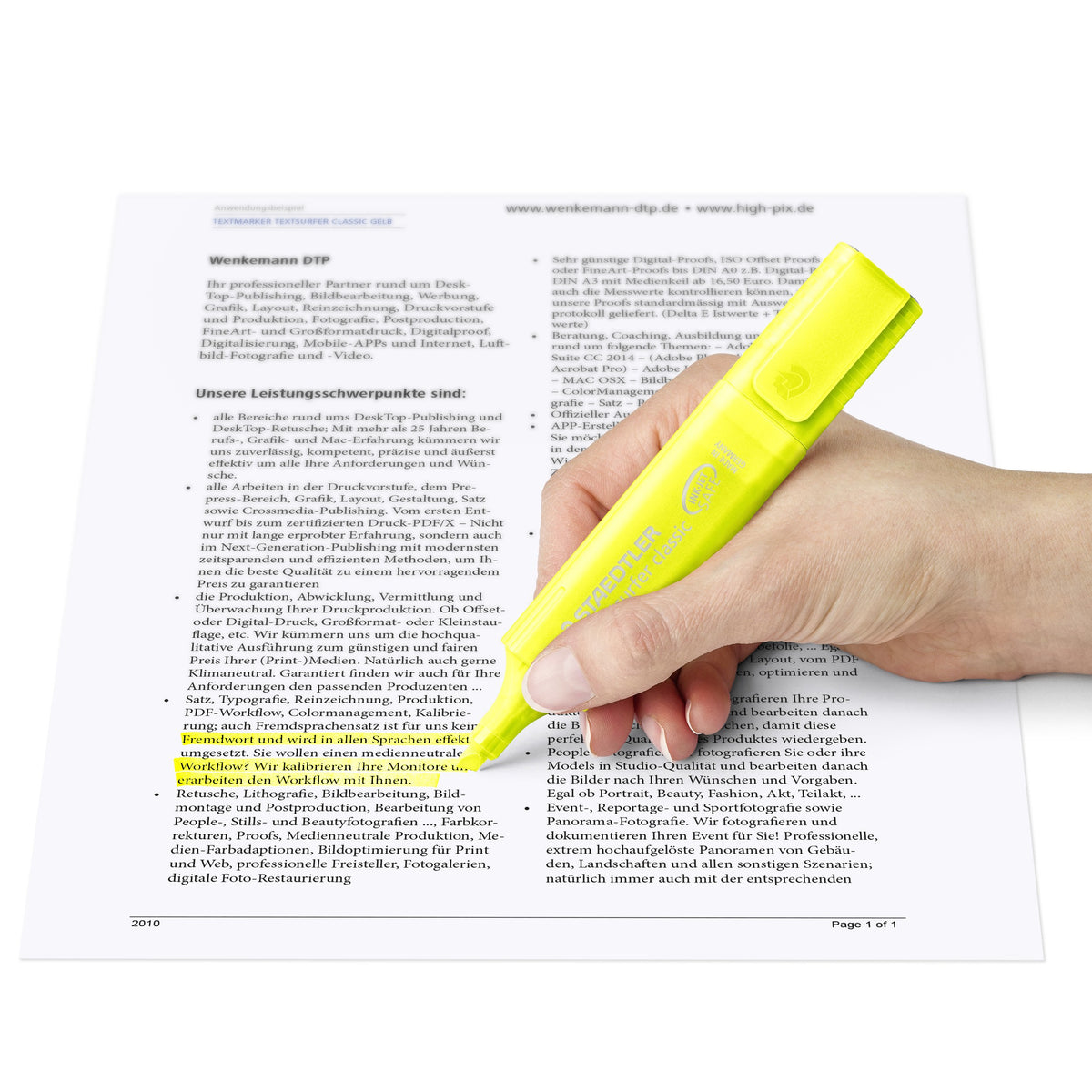 Hand highlighting a printed page with a translucent yellow Textsurfer classic rainbow colours pen
