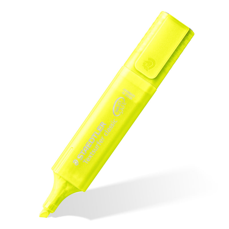 Single translucent yellow rainbow Textsurfer classic standing at an angle on its chisel tip