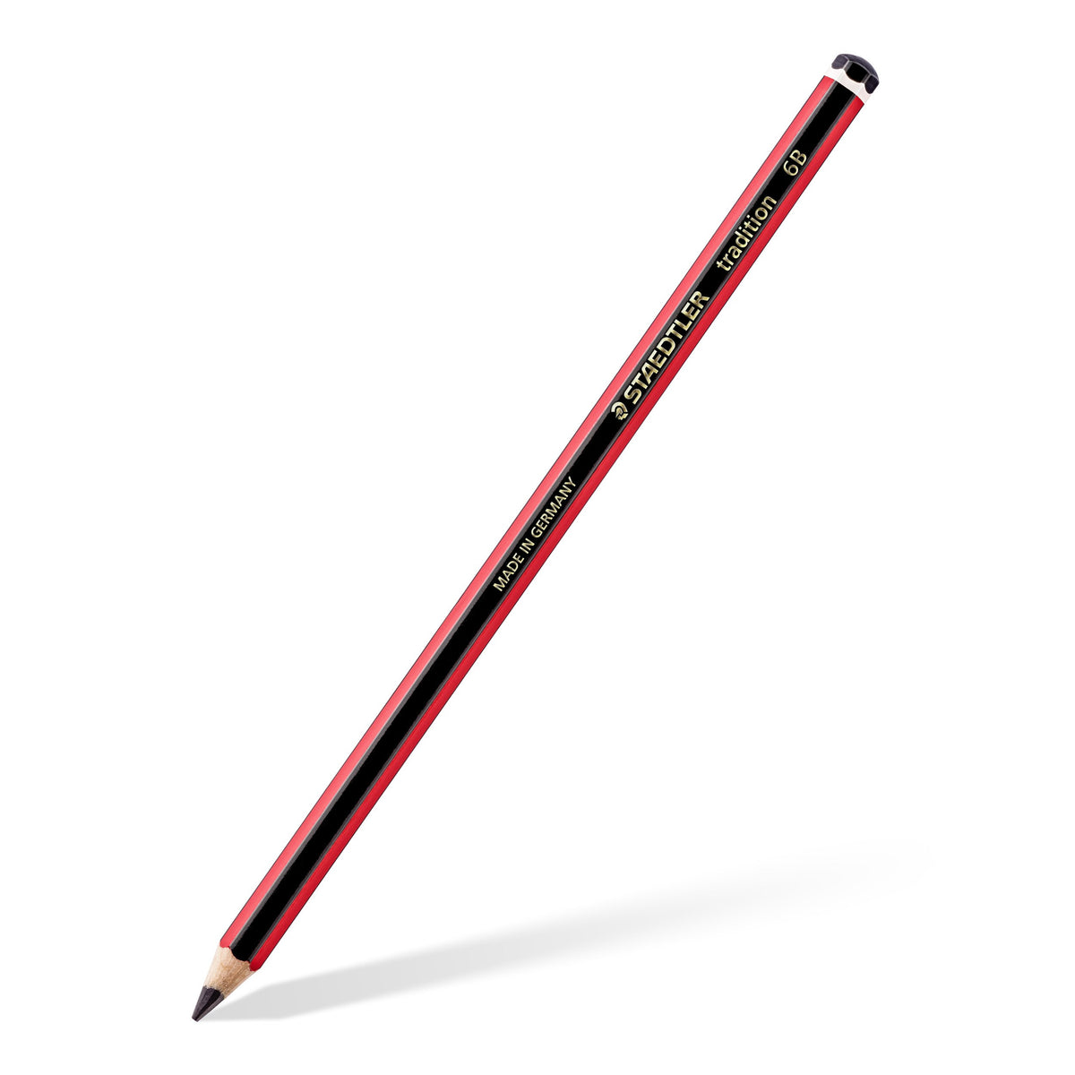A single Staedtler tradition 6B graphite pencil on an angle, red and black barrel with gold STAEDTLER lettering and a black end cap