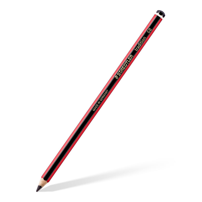 A single Staedtler tradition 6B graphite pencil on an angle, red and black barrel with gold STAEDTLER lettering and a black end cap