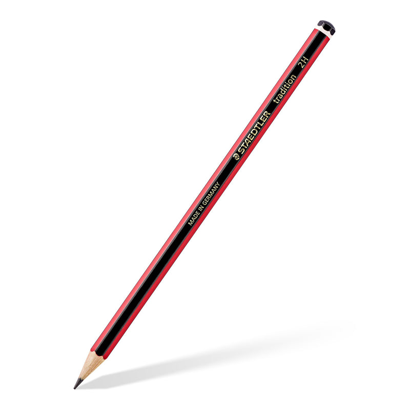 A Staedtler tradition 2H graphite pencil lying diagonally, red and black barrel with gold lettering and black end cap