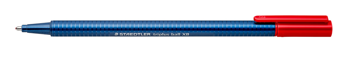 Staedtler triplus ball 437 XB red ballpoint pen laid flat with the red cap posted on its end and the blue dotted barrel and metal tip showing
