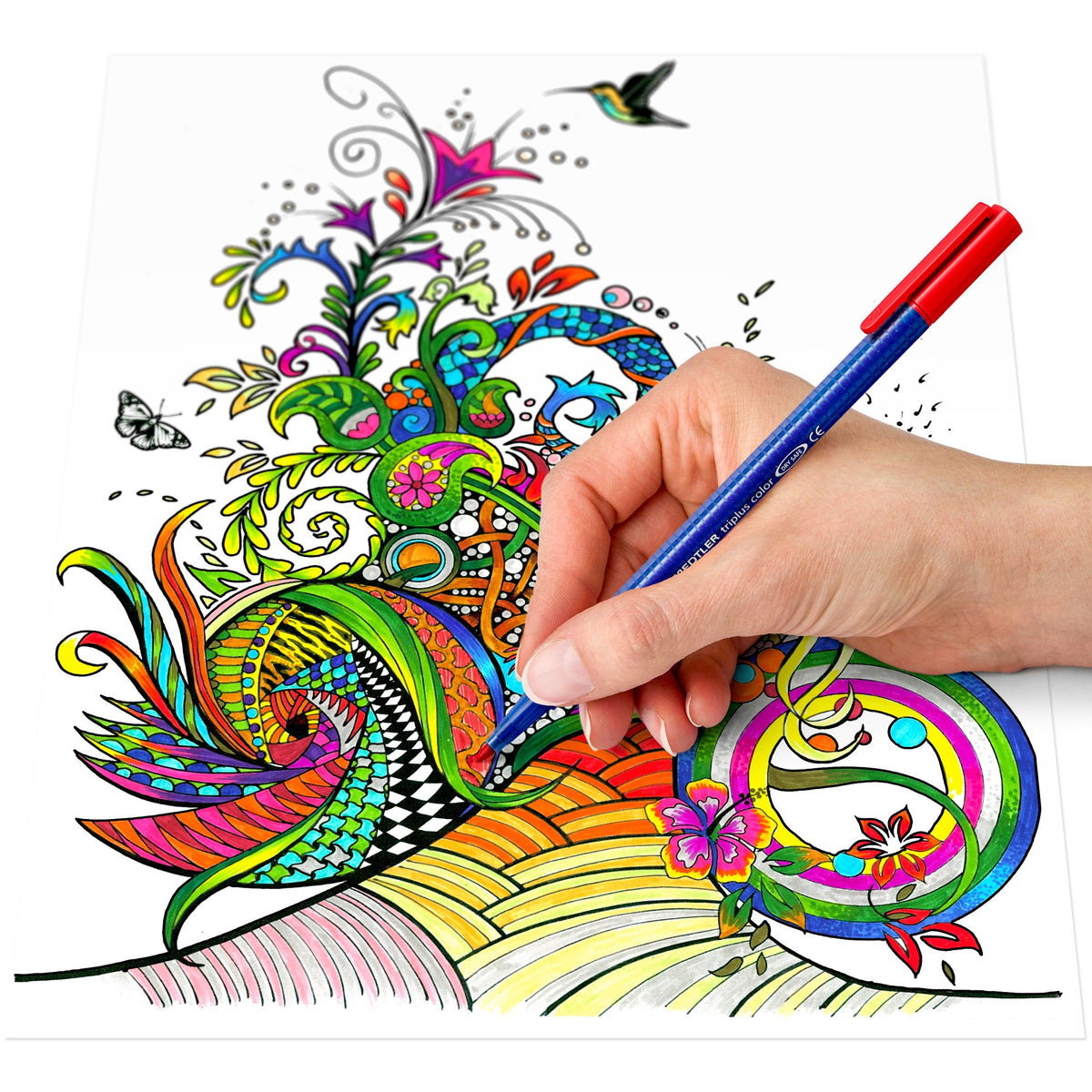 Hand colouring a swirling paisley flower design with a hummingbird using a Staedtler triplus color fibre-tip pen