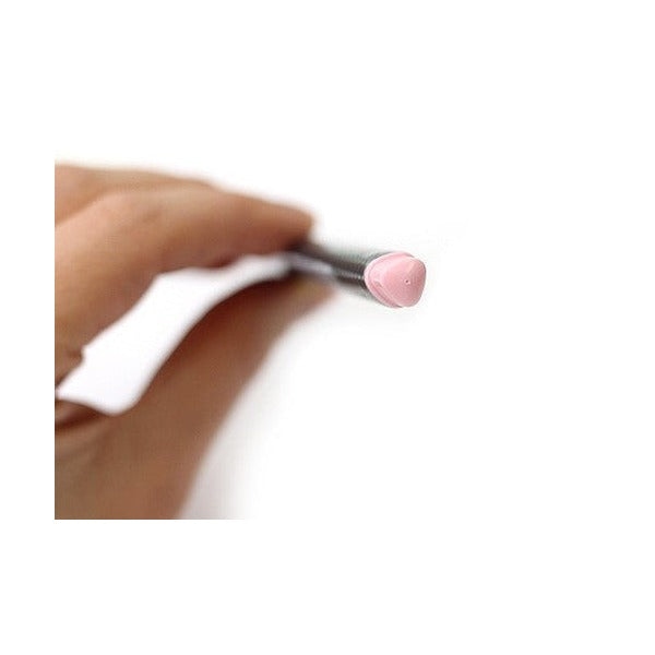 Hand holding a triplus fineliner by the barrel, pale pink triangular end cap in focus