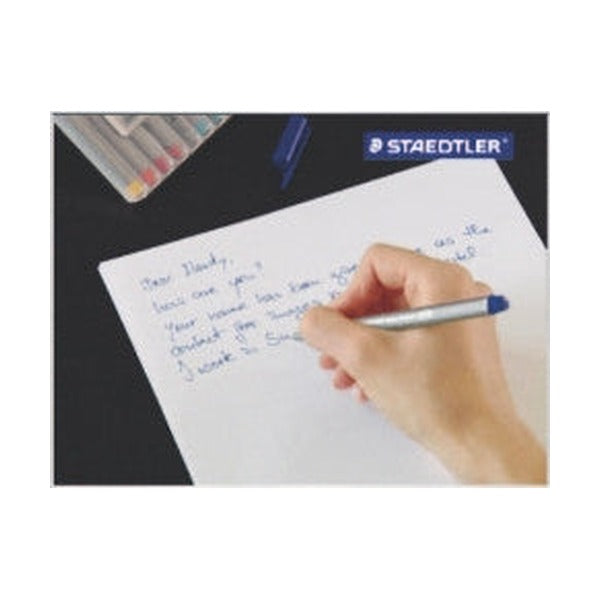 Hand writing a short letter in blue ink with a triplus fineliner, a row of triplus fineliners at the top of the page (another colour shown)