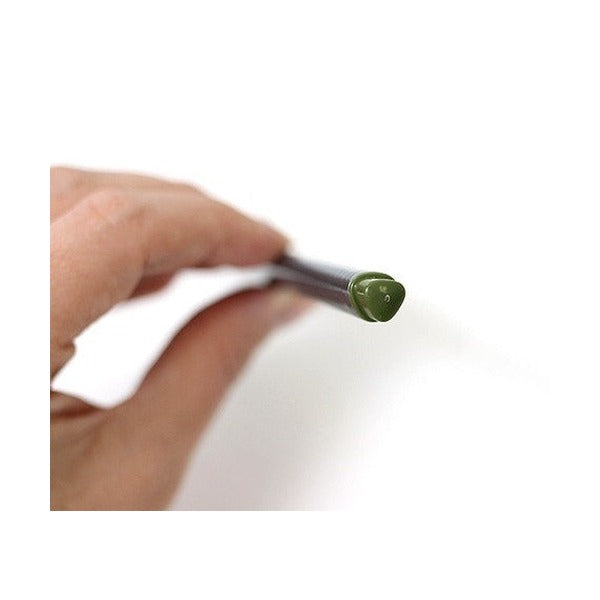 Fingers holding a triplus fineliner by the end to show the triangular olive green end cap