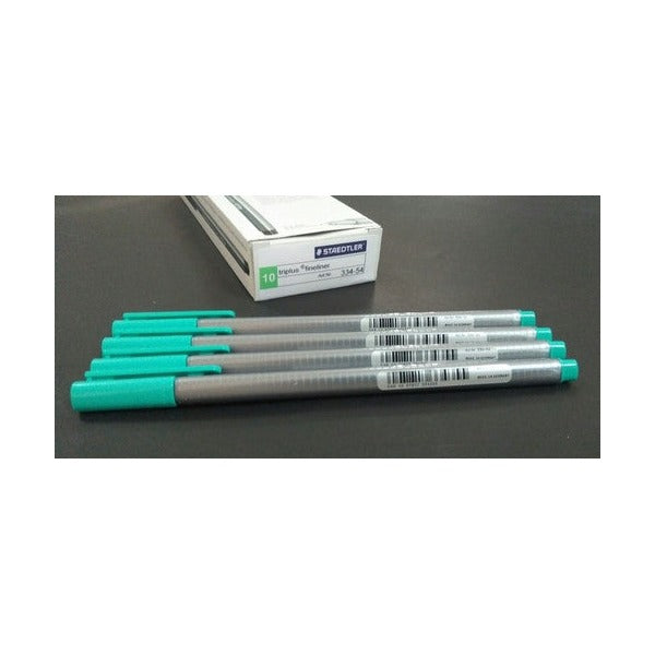 Earlier Staedtler cardboard box of 10 triplus fineliner 334-54 beside five turquoise pens with grey barrels on a dark surface
