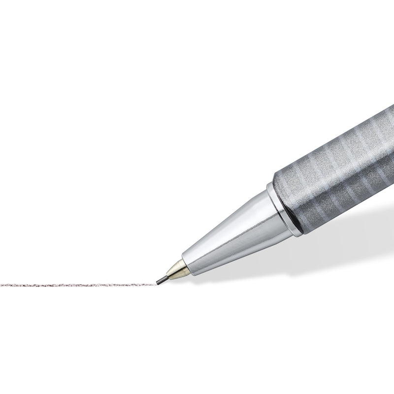 Close-up of the chrome-plated tip and slim lead sleeve of the triplus micro drawing a fine grey pencil line on white