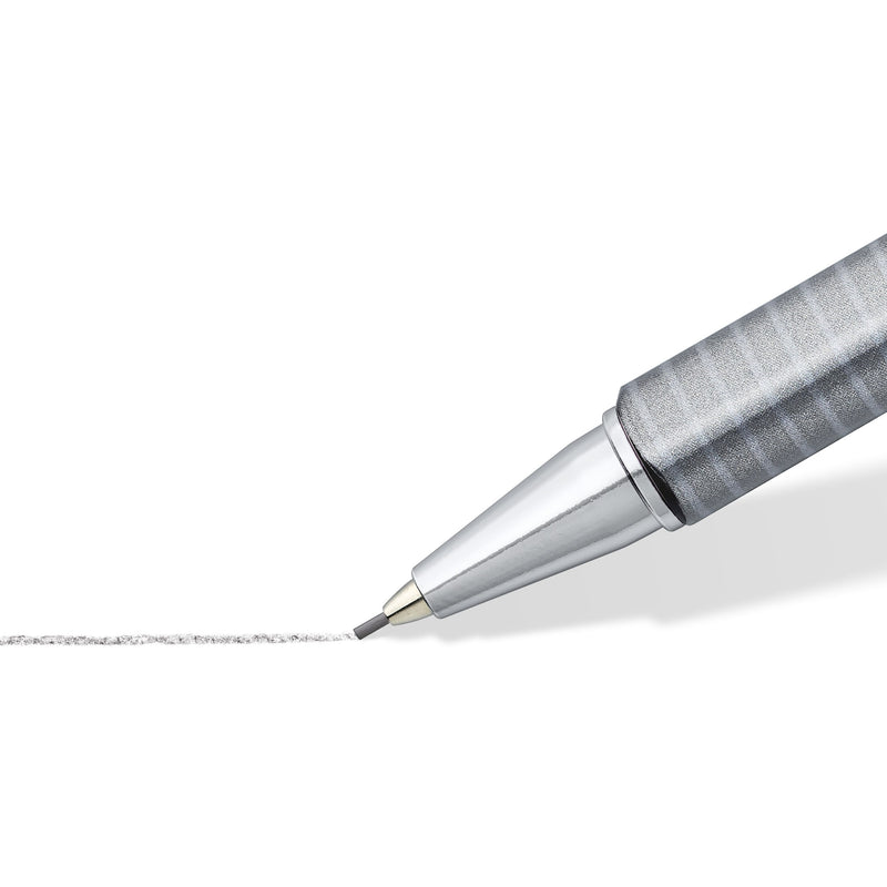 Chrome-plated tip of the triplus micro close up, the lead sleeve drawing a grey graphite line across white paper