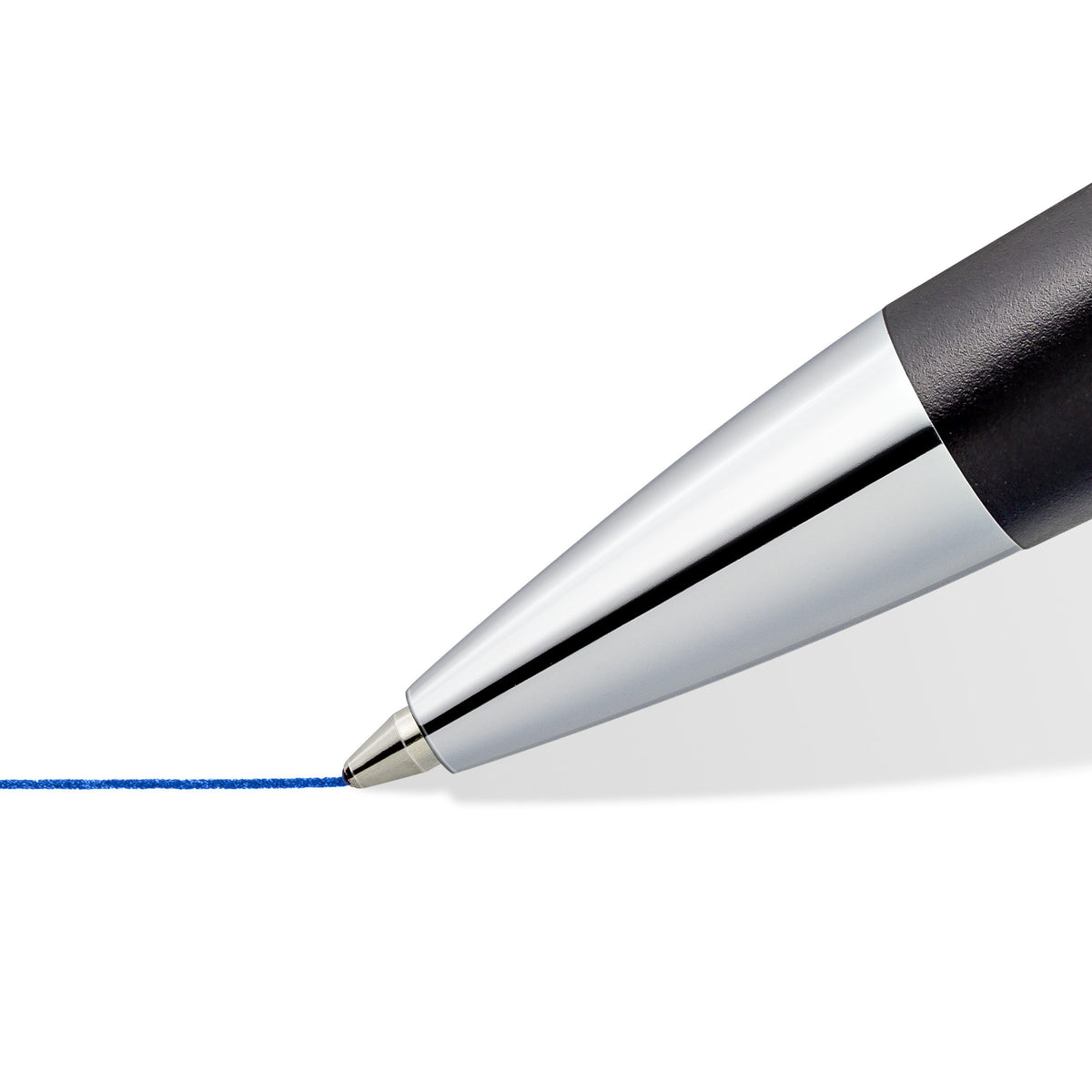 Close-up of the polished silver tip of an anthracite triplus ballpoint drawing a blue line