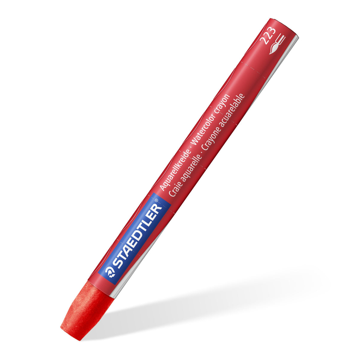 A single red Staedtler 223 watercolour crayon in its printed paper sleeve, shown on a diagonal against white
