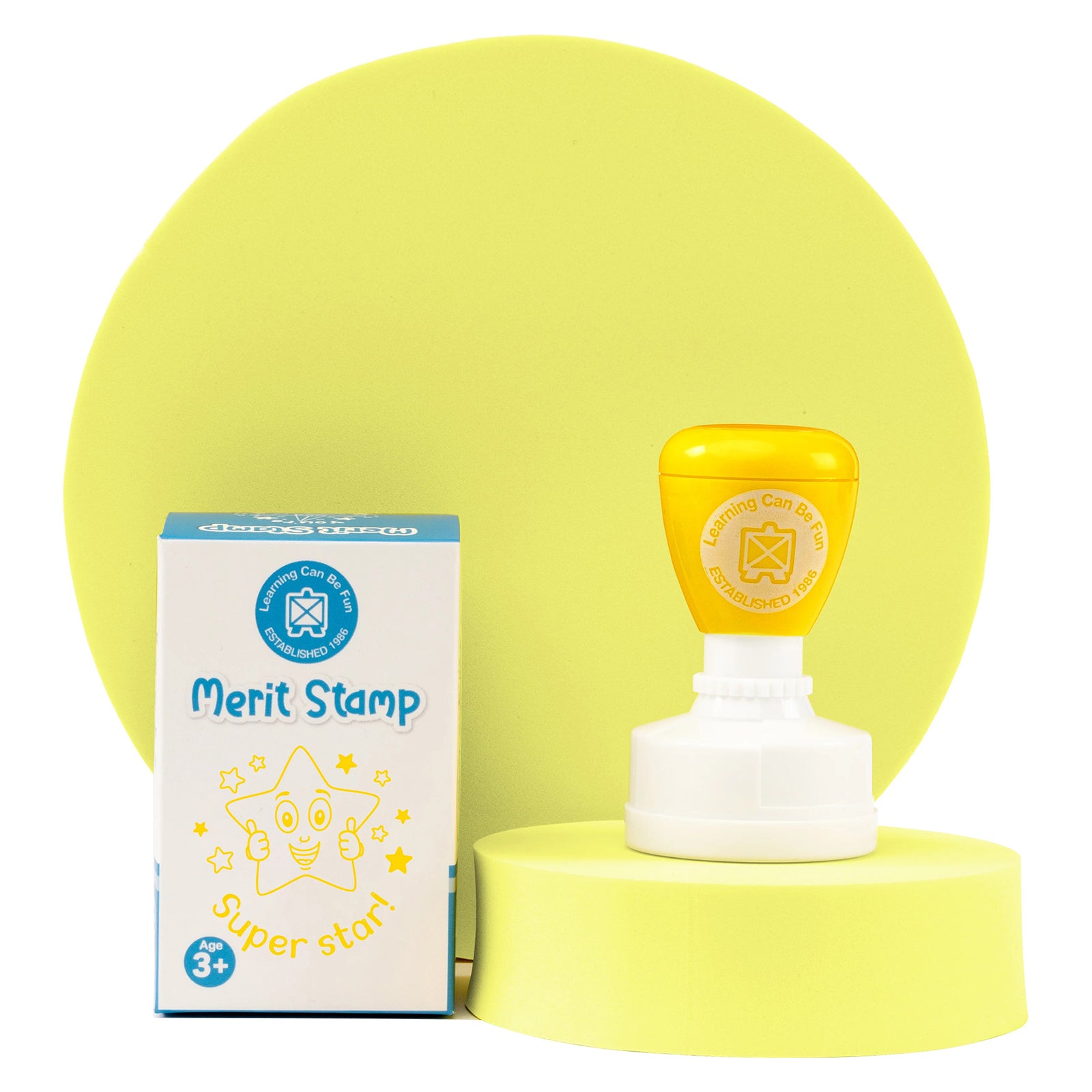 Super Star Merit Stamp displayed with retail packaging on a yellow presentation stand. The image shows the Learning Can Be Fun classroom reward stamp, packaging and cheerful star design for student encouragement.