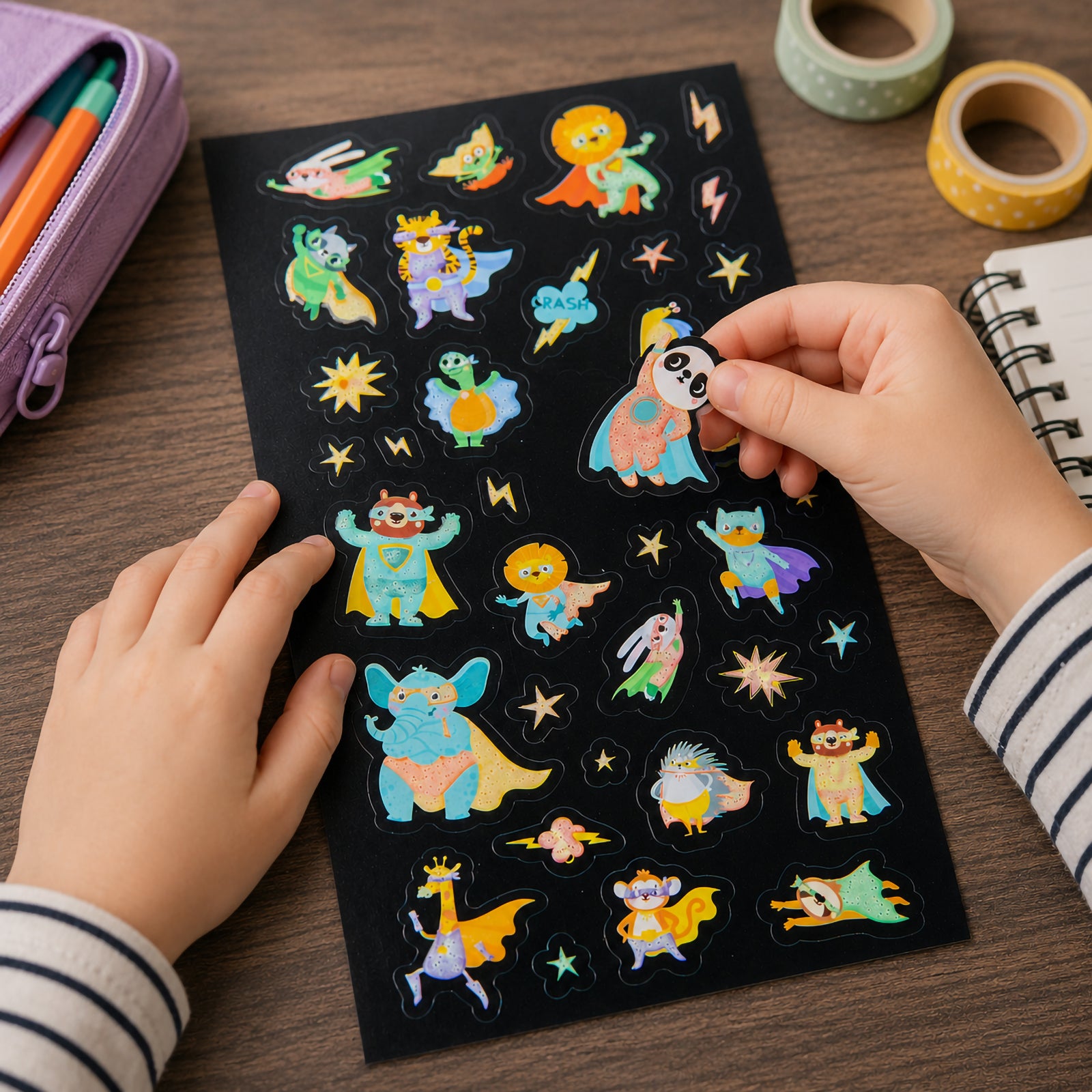 Child placing a superhero animal glow sticker onto a sticker sheet featuring colourful characters including pandas, lions, elephants and foxes dressed as superheroes. The glow in the dark designs encourage imaginative play and creative storytelling.